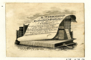 Ein altes Buch mit einer Rolle oben drauf, umgeben von Büchern und einem textgefüllten Papier, mit "Buchhändler" unten.